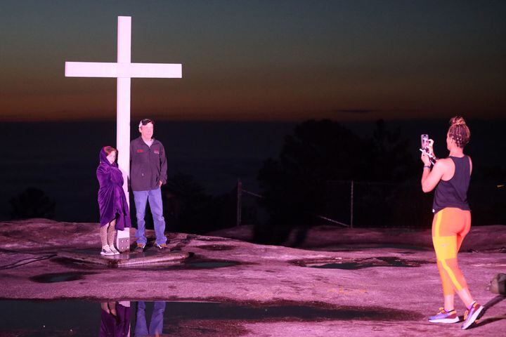 Nickey Townsend and his daughter Chasidy Townsend get a photo with the cross moments before the beginning of the 76th annual Easter Sunrise Service on the top of Stone Mountain on Sunday, April 17, 2022. Miguel Martinez/miguel.martinezjimenez@ajc.com