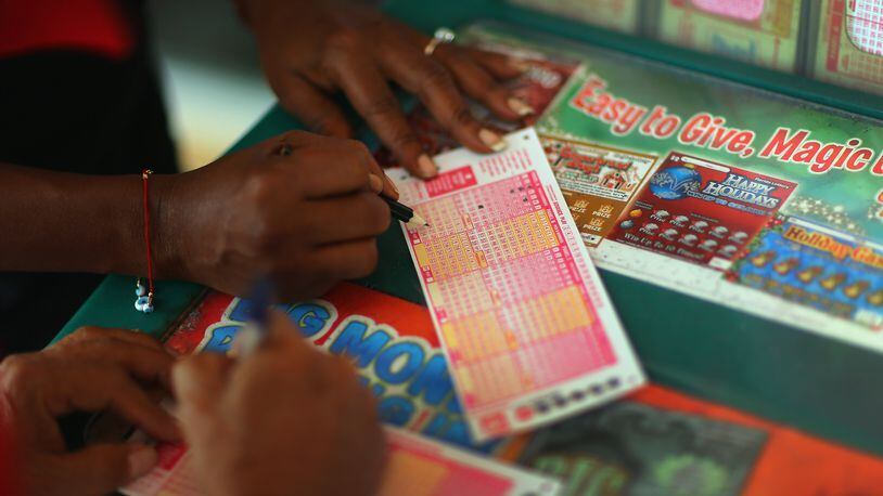 HOLLYWOOD, FL - NOVEMBER 28: Monti Young fills out her Powerball numbers as she buys a ticket at Circle News Stand on November 28, 2012 in Hollywood, Florida. The jackpot for Wednesday's Powerball drawing is currently at $550 million which is the richest Powerball pot ever. It is likely to rise even more as people continue to buy before tonights drawing. (Photo by Joe Raedle/Getty Images)