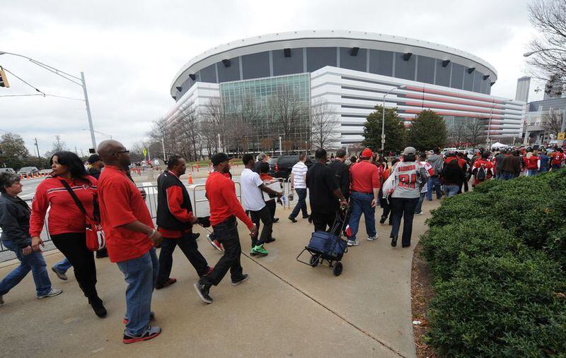 Atlanta Falcon fans walk from the Vine City Marta Station to the Atlanta Falcons NFC playoff game against the Seattle Seahawks in the Georgia Dome on Sunday, January 13, 2012. JOHNNY CRAWFORD / JCRAWFORD@AJC.COM
