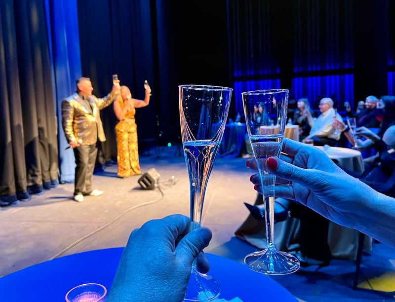 Anthony Rodriguez and Ann-Carol Pence are onstage for a toast to the grand opening of the Lawrenceville Arts Center. Photo by Bruce Johnson.