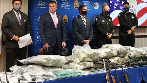Federal agents displayed seized drugs, cash and firearms during a Wednesday news conference to discuss a massive heroin bust that recently took place in Atlanta.