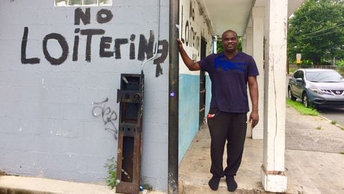 Toju Oris stands outside the store he has owned for 11 years in the English Avenue neighborhood. "Change here is inevitable," he said. Photo by Bill Torpy