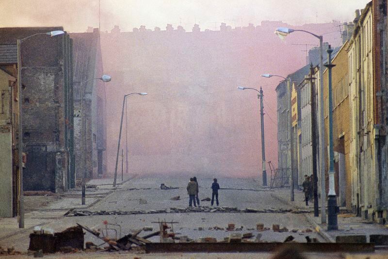 FILE - Haze from smoke bombs released by British troops in the bogside district of Londonderry, Northern Ireland, on Feb. 1972. Fifteen British soldiers who allegedly lied to an inquiry into Bloody Sunday, one of the deadliest days of the decades-long Northern Ireland conflict, will not face perjury charges, prosecutors said Friday, April 19, 2024. (AP Photo/Michel Laurent, File)