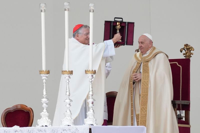 Pope Francis is flanked by Cardinal Francesco Moraglia, left, at the end of a mass in St. Mark's Square, Venice, Italy, Sunday, April 28, 2024. The Pontiff arrived for his first-ever visit to the lagoon town including the Vatican pavilion at the 60th Biennal of Arts. (AP Photo/Antonio Calanni)