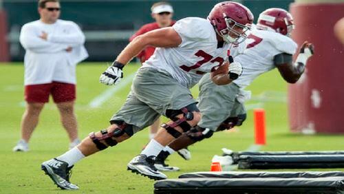 FILE - In this Aug. 23, 2016, file photo, Alabama offensive lineman Jonah Williams (73) works on a drill during NCAA college football practice at the Thomas-Drew Practice Fields in Tuscaloosa, Ala. Alabama All-American Cam Robinson thinks Jonah Williams has been better than he was as a freshman. Crimson Tide offensive line coach Mario Cristobal calls his young right tackle "the best I've seen." (Vasha Hunt/AL.com via AP, File)