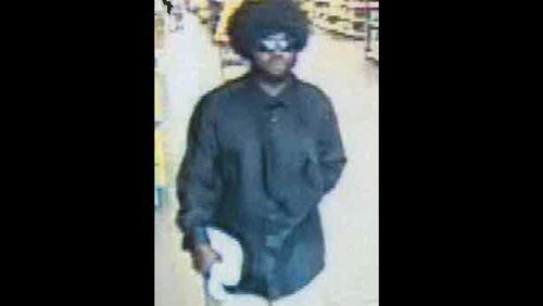 Cobb County police say this man with a wig and sunglasses robbed two Walmart stores within 15 minutes on Aug. 14, 2018.