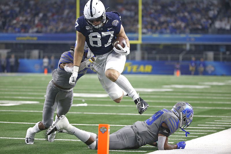 Penn State tight end Pat Freiermuth (87) leaps past Memphis defensive backs Chris Claybrooks (7) and Carlito Gonzalez (29) in an attempt to reach the end zone during the Cotton Bowl on Saturday, Dec. 28, 2019, in Arlington, Texas. Freiermuth was ruled out of bounds inside the 5-yard line. (Ron Jenkins/AP)