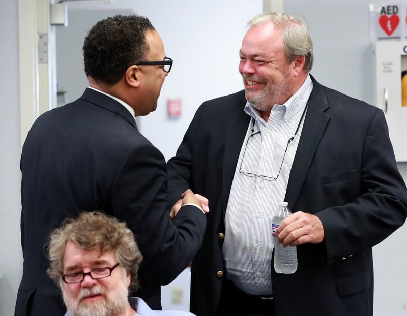 Fort Mac LRA board chairman Cassius Butts (left) greets developer Stephen Macauley (right) as he arrives for the McPherson Implementing Local Redevelopment Authority Board Meeting at Fort Mac LRA on Thursday, July 11, 2019, in Atlanta. Curtis Compton/ccompton@ajc.com
