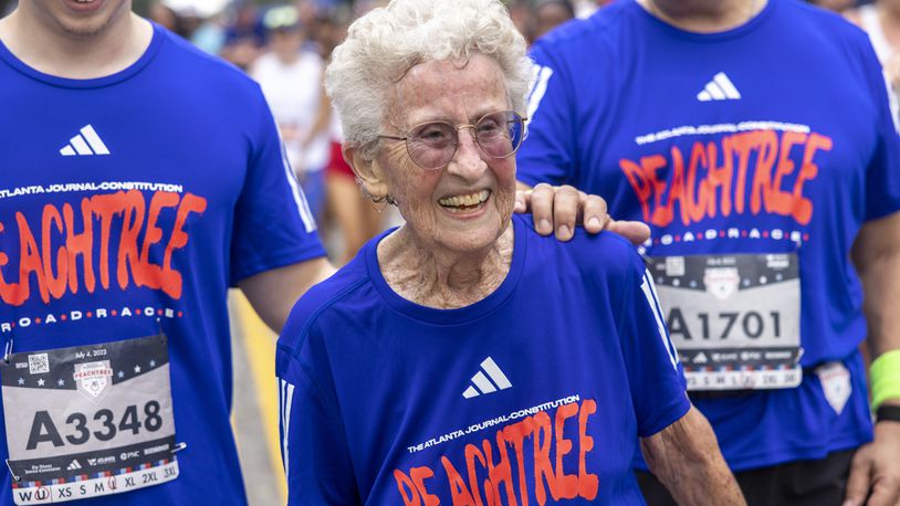 Betty Lindberg, 98, crosses the finish line of the 54th running of the Atlanta Journal-Constitution Peachtree Road Race in Atlanta on Tuesday, July 4, 2023.  Lindberg set the 5K World record in 2022 in the 95-99 age group.