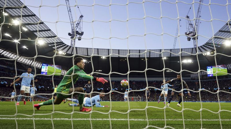 Real Madrid's Rodrygo shoots on a clearance from Manchester City's Ederson to score the opening goal , during the Champions League quarterfinal, second leg soccer match between Manchester City and Real Madrid, at the Etihad Stadium, in Manchester, England. Wednesday April 17, 2024. (Martin Rickett/PA via AP)