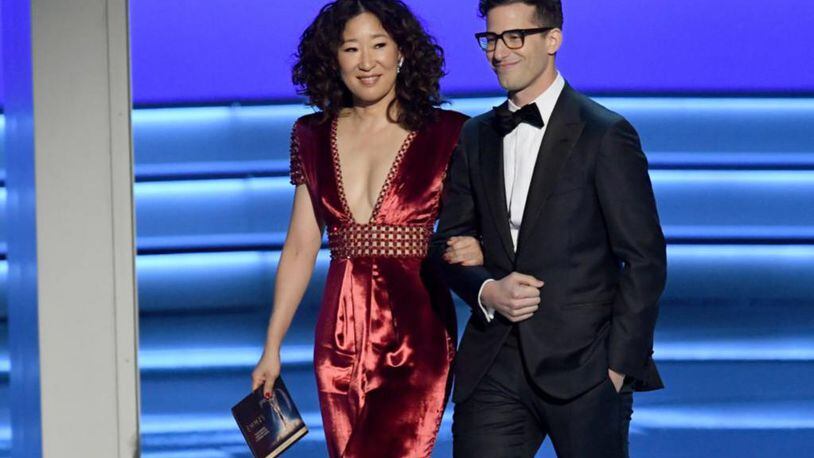 Sandra Oh (L) and Andy Samberg walk onstage during the 70th Emmy Awards at Microsoft Theater on September 17, 2018 in Los Angeles, California.