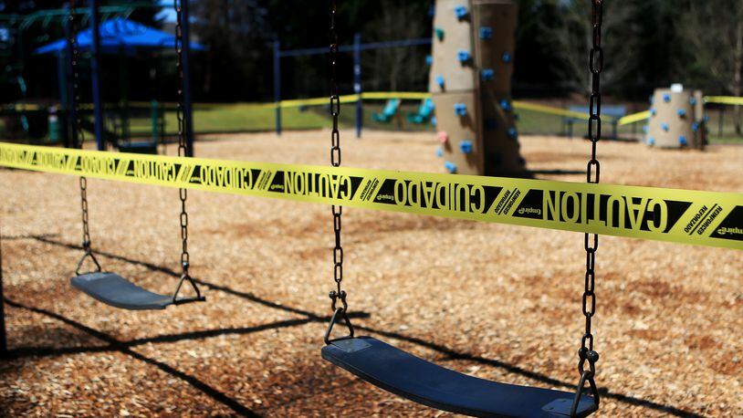 Caution tape surrounds Woodland Gate Playground on Wednesday, March 25,  2020, in Smyrna, Georgia. Some playgrounds in metro Atlanta have closed due to the outbreak of the coronavirus. (Christina Matacotta, for The Atlanta Journal-Constitution)