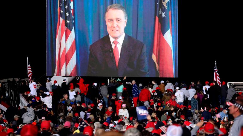 Then-Sen. David Perdue speaks via video monitor during a rally ahead of a Senate runoff in Dalton, Georgia, in January. (Sandy Huffaker/AFP/Getty Images/TNS)