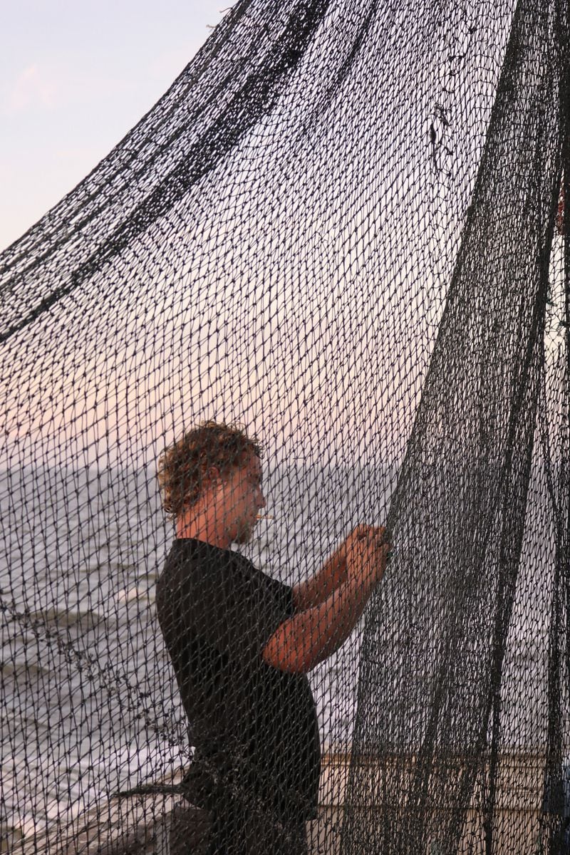 Jake mends nets that often are torn by sharks trying to steal the catch.
Contributed by Eric Dusenbery