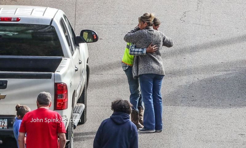 Onlookers embrace near the scene of a deputy's shooting in Douglas County on Wednesday.