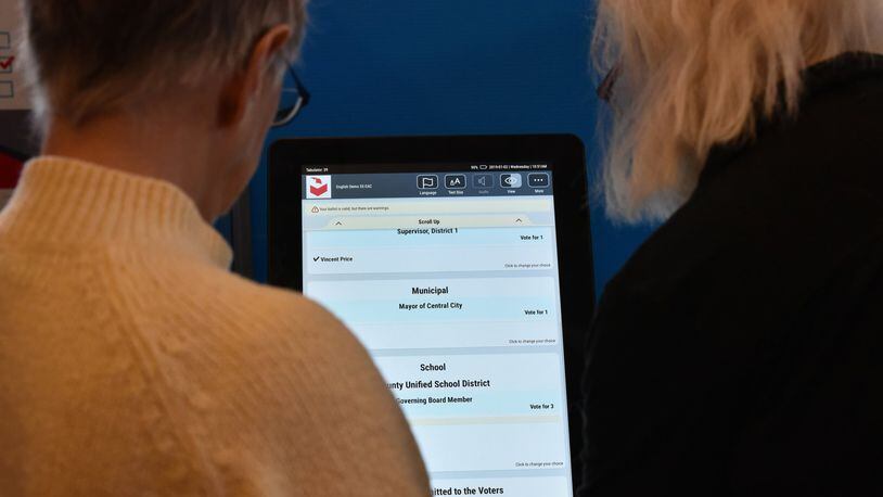Voters check out Dominion Voting’s digital voting system at The Depot in January. Election companies demonstrated voting systems to the public and to officials at the event preceding the opening of Georgia’s General Assembly session. HYOSUB SHIN / HSHIN@AJC.COM