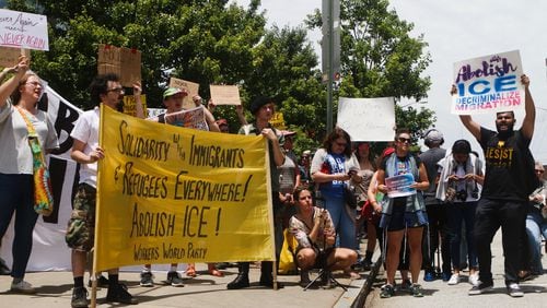 #NeverAgainIsNow protesters on Monday demonstrated for the rights of unauthorized immigrants outside the Atlanta field office of Immigration Customs and Enforcement. Two protesters were arrested.