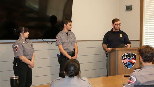 Chad West (at podium), community outreach officer with the Milton Police, speaks with participants in the department's student Explorers program.