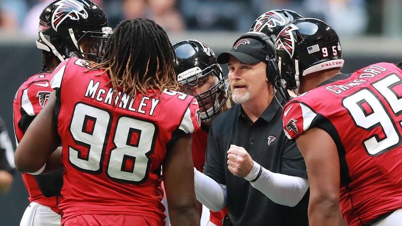 Atlanta Falcons head coach Dan Quinn talks with his defense during a first half time out against the Tampa Bay Buccaneers Sunday, Oct. 14, 2018, in Atlanta.