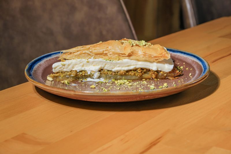 The baklava ice cream sandwich at Chelo is a pie-shaped slice of baklava filled with vanilla ice cream. Courtesy of Chelo
