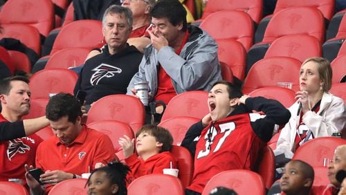 There are plenty of empty seats in Mercedes-Benz Stadium and several fans appear disinterested while the Atlanta Falcons beat the Jacksonville Jaguars 24-12 Sunday, Dec. 22, 2019, in Atlanta.
