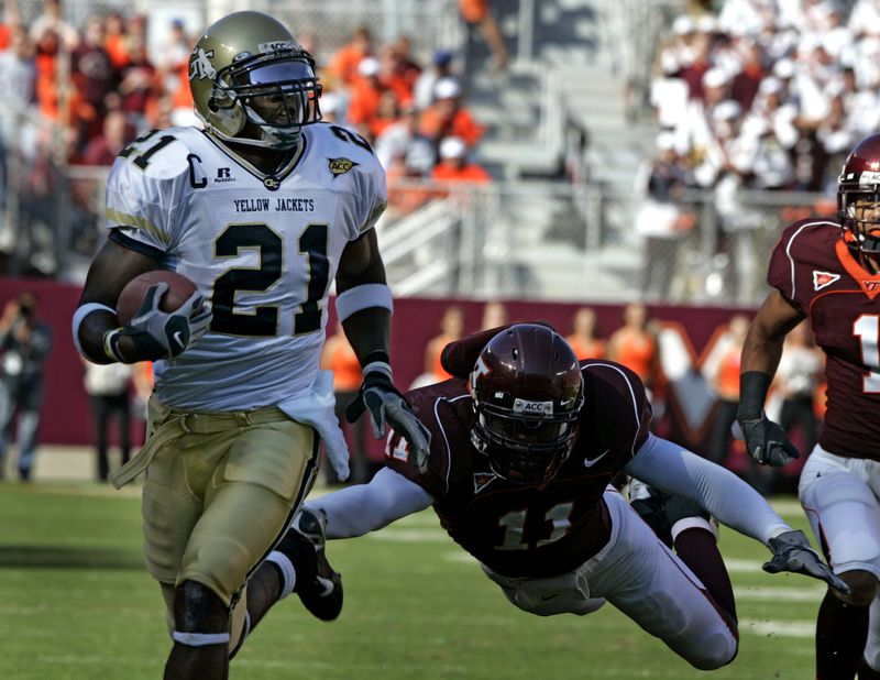 ** RETRANSMISSION TO CORRECT OBJECT NAME AND PLAYER ** Georgia Tech wide receiver Calvin Johnson (21) runs is for a touchdown as Virginia Tech defender Xavier Adibi (11) makes a last attempt for a tackle during first half action of the Georgia Tech-Va Tech Atlantic Coast Conference college football game at Lane stadium in Blacksburg, Va., Saturday Sept. 30, 2006. (AP Photo/Steve Helber)