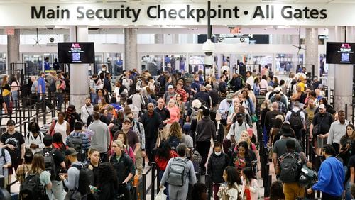 File: Passengers move through TSA security lines at the main security checkpoint area at the Hartsfield-Jackson Atlanta International Airport. 
Miguel Martinez /miguel.martinezjimenez@ajc.com