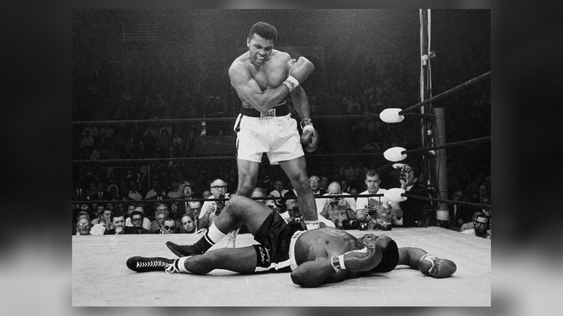 Heavyweight champion Muhammad Ali, then known as Cassius Clay, stands over fallen challenger Sonny Liston in 1965. (AP Photo/John Rooney)
