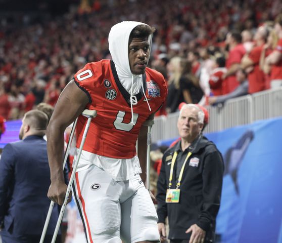 Georgia Bulldogs tight end Darnell Washington (0) is on crutches during the fourth quarter of the College Football Playoff Semifinal between the Georgia Bulldogs and the Ohio State Buckeyes at the Chick-fil-A Peach Bowl In Atlanta on Saturday, Dec. 31, 2022.  Georgia won, 42-41. (Jason Getz / Jason.Getz@ajc.com)