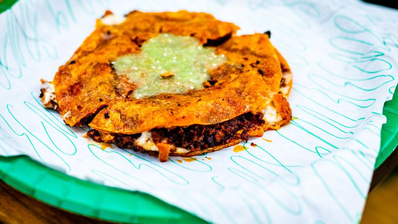 The choriqueso at Supremo Taco is a quesadilla filled with chorizo and cheese, fried to a delectably crispy snap, cut into triangles and drizzled with salsa verde. CONTRIBUTED BY HENRI HOLLIS