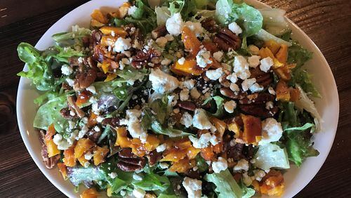 The house salad at Fire Stone Wood Fired Pizza & Grill is a delicious combination of mixed greens, dried peaches, candied pecans and blue cheese tossed in apple cider vinaigrette / Photo: Ligaya Figueras