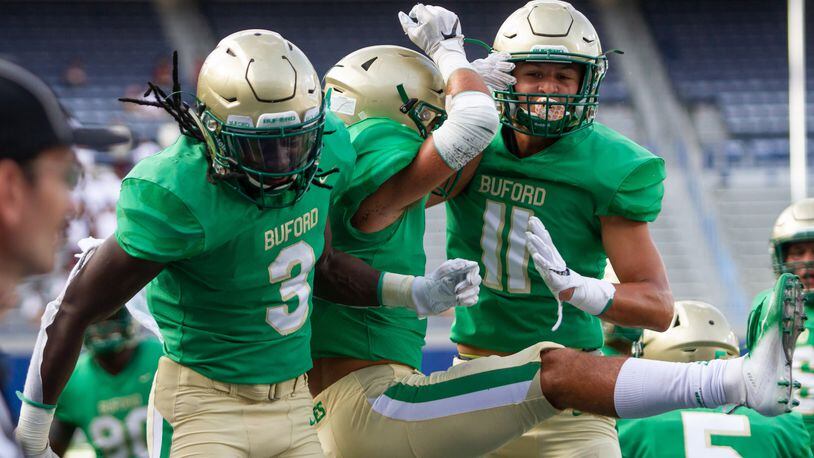 Buford running back Derrian Brown (left)  celebrates with his teammates after a touchdown against Tucker during the 2018  Corky Kell Classic Friday, Aug.17, 2018, at Georgia State Stadium in Atlanta.