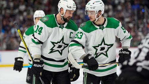 Dallas Stars left wing Jamie Benn (14) confers with center Wyatt Johnston (53) in the second period of Game 4 of an NHL hockey Stanley Cup playoff series against the Colorado Avalanche Monday, May 13, 2024, in Denver. (AP Photo/David Zalubowski)