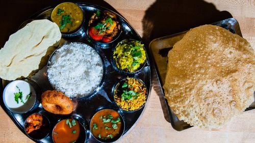 Madras Mantra’s special thali includes a chef’s selection of three curries, sambar, rasam, plain rice, special rice, vada, raita, pickle, dessert and fruit. It’s served here with a globe of crispy poori, but can also be served with naan. CONTRIBUTED BY HENRI HOLLIS