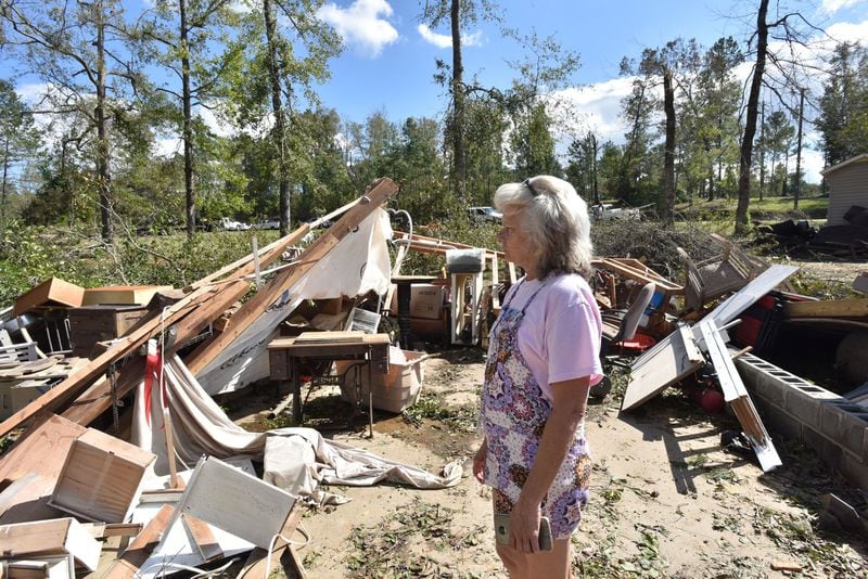 Sharon Granade stands near destroyed two-car garage after Tropical Storm Michael passed in Roberta, Ga., on Oct. 11, 2018. HYOSUB SHIN / HSHIN@AJC.COM