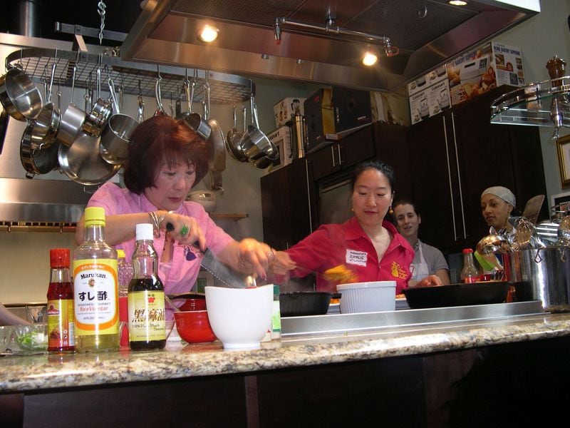Natalie Keng (right) teaches a cooking class with her mother, Margaret Keng. They also give tours of international markets and grocery stores. Courtesy of Natalie Keng.