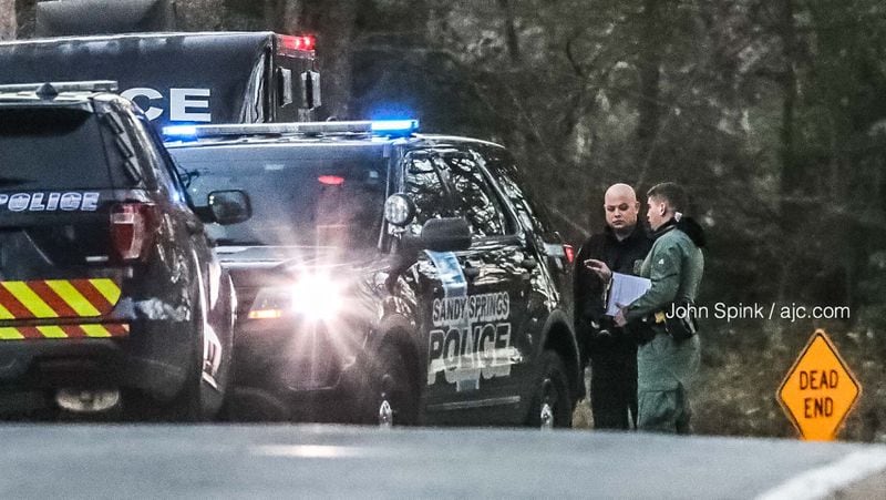 Sandy Springs police collect evidence along Conley Road on Wednesday morning after tracking a suspect accused of stealing GPS-equipped items from a bait car.