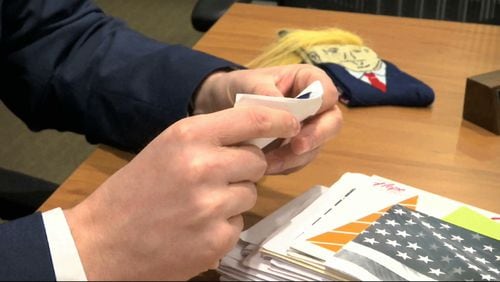 In this image from video, Electoral College elector Brian Fairbrother looks through mail he has received in Shelby Township, Mich., on Tuesday, Dec. 13, 2016. And you thought Election Day was in November. Electors are gathering in every state Monday to formally elect Donald Trump president even as anti-Trump forces try one last time to deny him the White House. Republican electors say they have been deluged with emails, phone calls and letters urging them not to support Trump. Many of the emails are part of coordinated campaigns.(AP Photo/Mike Householder)