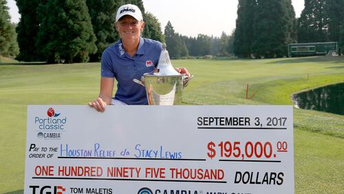Stacy Lewis shows off the winner's check on the 18th green after her victory during the final round of the LPGA Cambia Portland Classic. Lewis donated all of her winnings to the Hurricane Harvey Houston Relief effort.