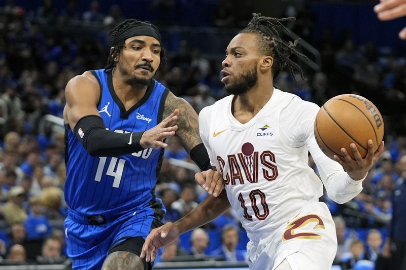 Cleveland Cavaliers guard Darius Garland (10) drives to the basket against Orlando Magic guard Gary Harris (14) during the first half of Game 4 of an NBA basketball first-round playoff series, Saturday, April 27, 2024, in Orlando, Fla. (AP Photo/John Raoux)