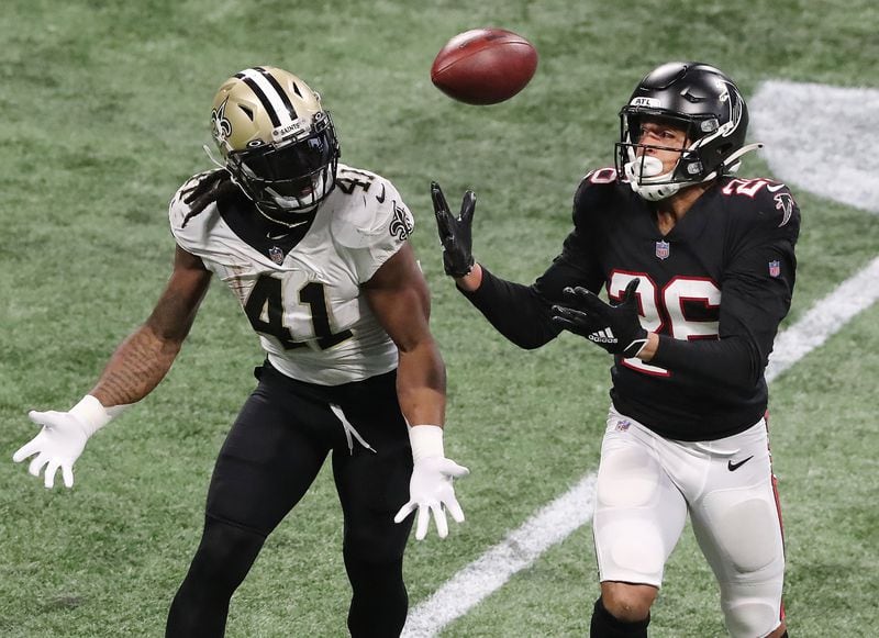 Falcons cornerback Isaiah Oliver breaks up a pass to Saints running back Alvin Kamara but can’t come down with the interception during the fourth quarter Sunday, Dec. 6, 2020, at Mercedes-Benz Stadium in Atlanta.  (Curtis Compton / Curtis.Compton@ajc.com)