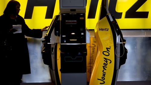 In this file photo, a customer checks in at a Hertz car rental counter at Hartsfield-Jackson Airport, in Atlanta. Most car rental reservations can easily be canceled or changed up until you pick up the vehicle. If prices fall, you can rebook at the lower rate. (AP Photo/David Goldman, File)