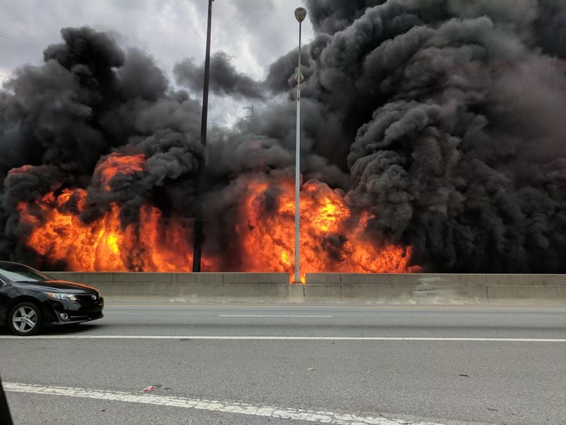  Motorists pass by a colossal fire that caused the collapse of I-85 in Midtown Atlanta Thursday evening. (Photo by Jackson Klinefelter)