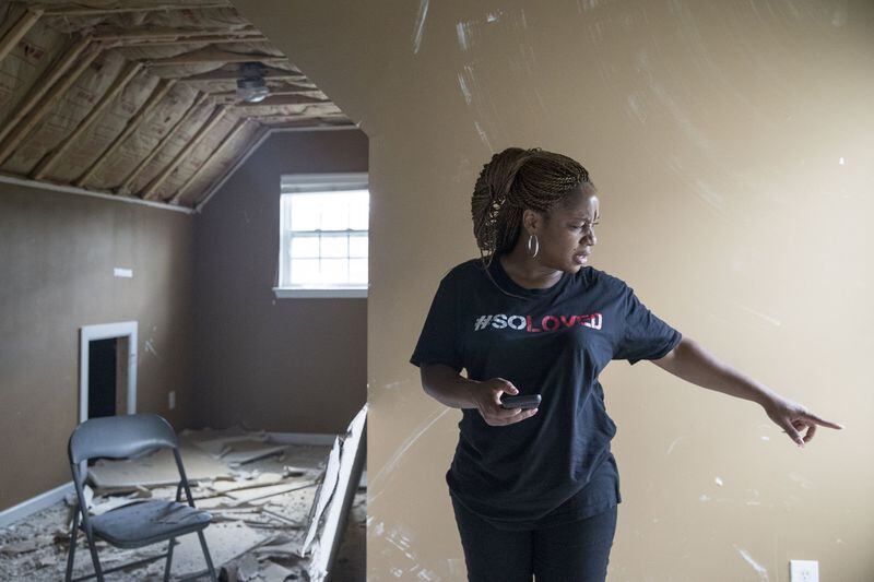 07/02/2018 — Fairburn/South Fulton, GA - Crystal Shaw surveys her abandoned house in the Chestnut Ridge subdivision in South Fulton, Monday, July 2, 2018. Crystal and her family, including her husband and two children, have been staying at an extended stay hotel since a tornado ripped through their subdivision in March. ALYSSA POINTER/ALYSSA.POINTER@AJC.COM