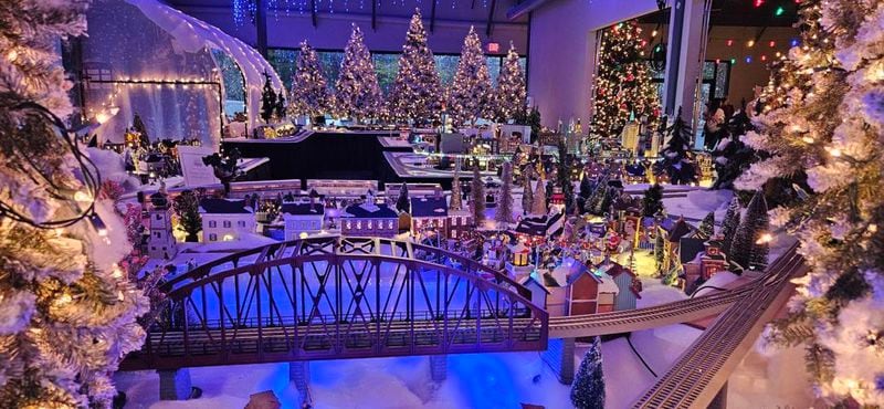 The Neighborhood Christmas Train Experience includes six running Lionel trains, more than 300 houses, churches, mountain-top chalets, diners, an amusement park and even a Home Depot. (Photo Courtesy of the Galucki family)