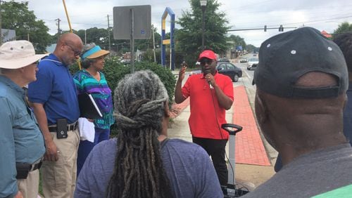 DeKalb County Commissioner Larry Johnson (center) speaks to residents near the corner of Candler and Glenwood roads about recent infrastructure improvements and his vision for the area.