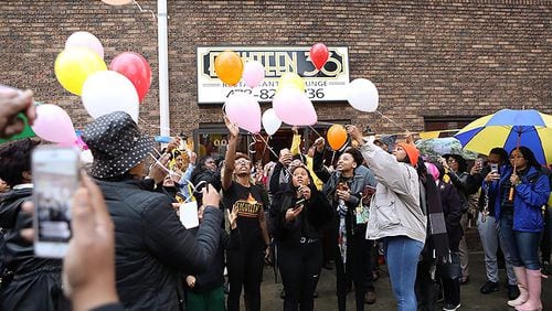 Mourners release balloons in memory of Anitra Gunn in front at the Eighteen36 Restaurant and Lounge, where she worked, in Fort Valley on Thursday, February 20, 2020. (Photo/Leah Yetter for the AJC)