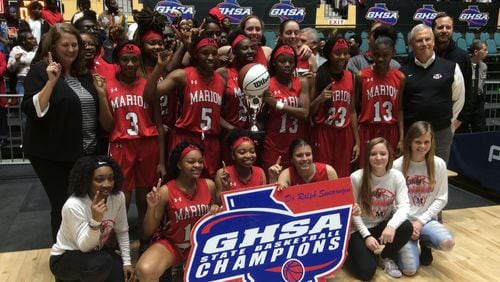 Marion County coach Fran McPherson (left) and her team celebrate their 50-38 victory over Calhoun County in the Class A private-school final Wednesday at the Macon Coliseum that gave the Eagles their first girls basketball state championship in school history.