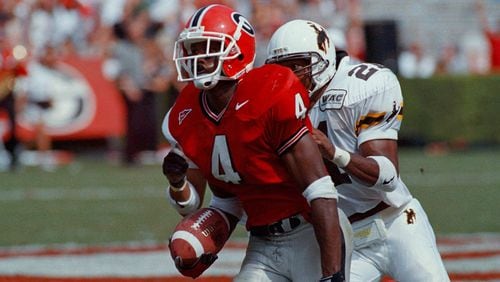 Georgia wide receiver Champ Bailey, left, scampers away from Wyoming safety Greg Van Leer enroute to a 51-yard touchdown pass in the second quarter of their game on Saturday, Sept. 19, 1998, at Sanford Stadium in Athens, Ga. The Bulldogs are currently ranked No. 12 in the nation. (AP Photo/Erik S. Lesser)