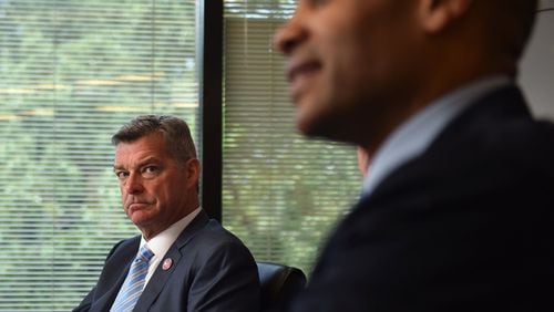 New Hawks owner Antony 'Tony' Ressler (background) and partner Grant Hill in a recent interview at the AJC.
